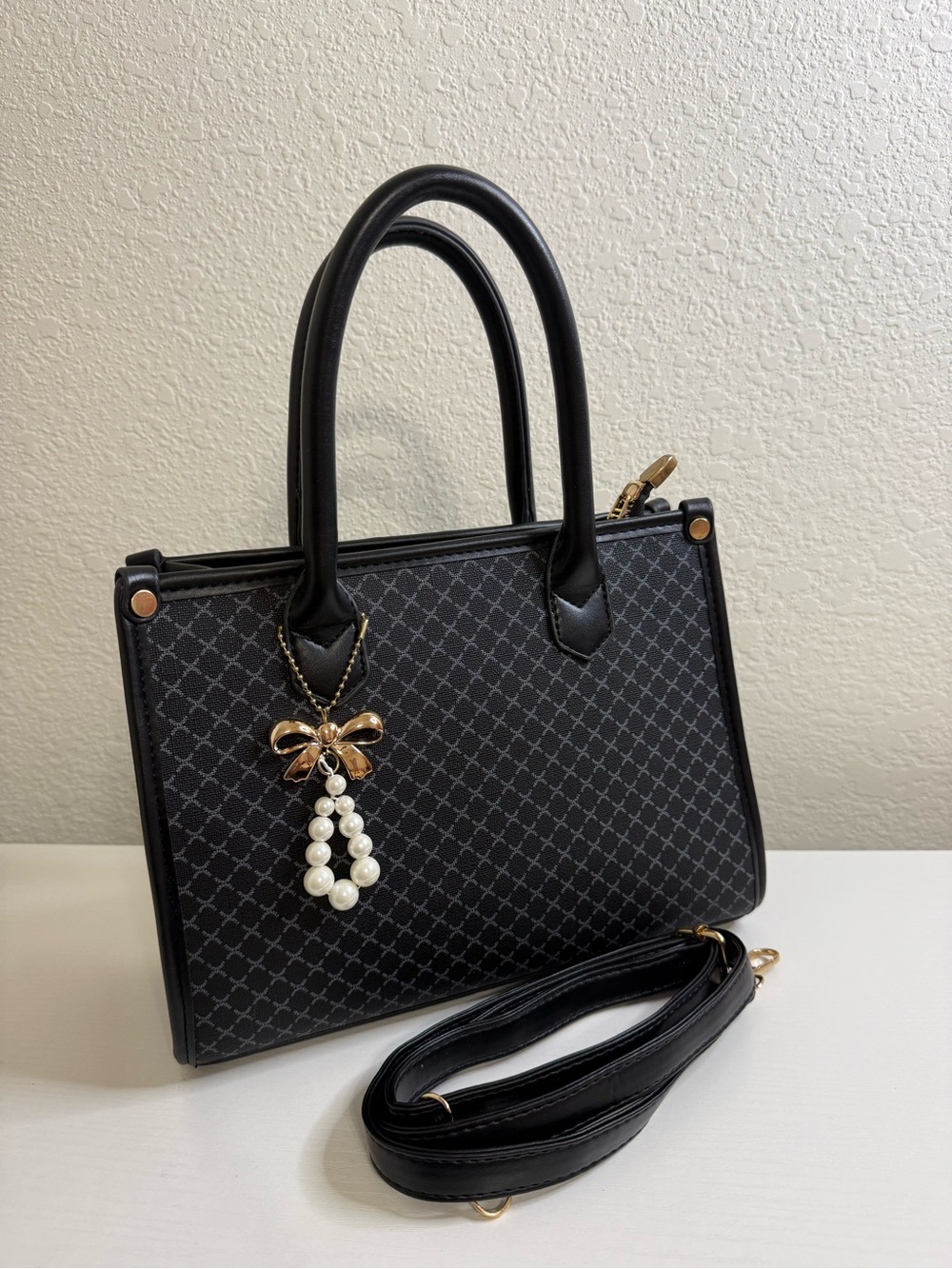 Elegant Black Patterned Tote Bag with Pearl Bow Charm